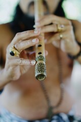 A Balinese musician plays a bamboo flute, known locally as a Suling, during a traditional music...