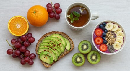 Flat Lay of Healthy Food with Avocado Toast, Smoothie Bowl, Fruits, and Herbal Tea