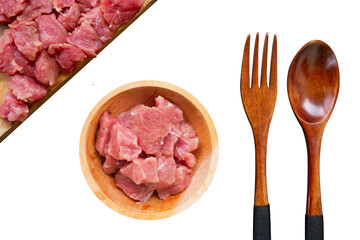 flat lay of raw meat in a wooden bowl with wooden spoon and fork isolated on transparent background