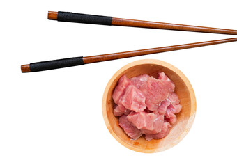 beef in a wooden bowl and chopsticks isolated on white