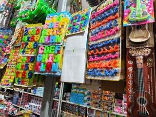 Naklejka premium Educational Toy Magnet Letters and Numbers Displayed for Sale, Children's Toys and Alphabet Learning Materials in a Retail Store