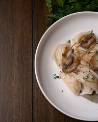 Traditional dumplings with mushrooms and herbs on plate