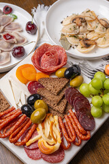 Traditional meal with dumplings and assorted cured meats on rustic table
