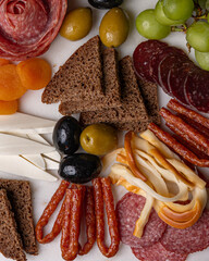 Assorted charcuterie with cheese olives bread and sausages