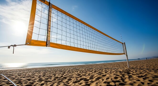 Beach volleyball net on sandy shore with ocean and clear blue sky on a sunny day - Powered by Adobe