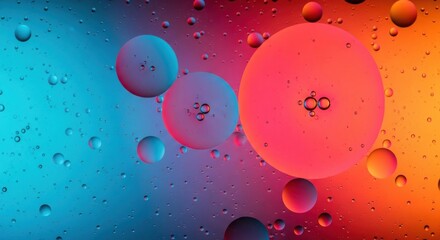 Abstract macro photograph of colorful oil and water bubbles with a vibrant gradient background blending blue and orange tones