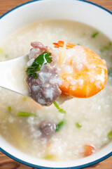 top view fresh shrimps and beef porridge at vertical composition