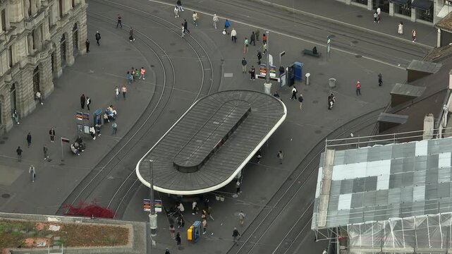 day time zurich city center tram station crowded street square aerial panorama 4k switzerland  