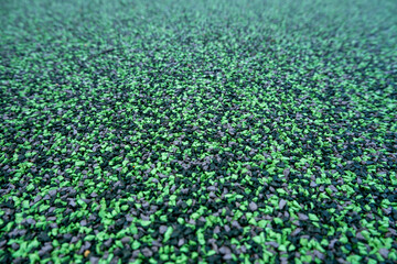 Close-up of rubber softfall granules, used as impact-absorbing safety flooring in Australian...