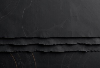 Torn black paper layers on dark background