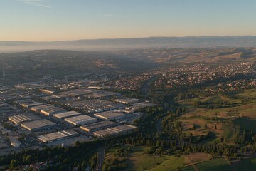 Obraz premium Aerial View of Industrial Area and Green Landscape Early Morning Photography Urban Environment Scenic Perspective