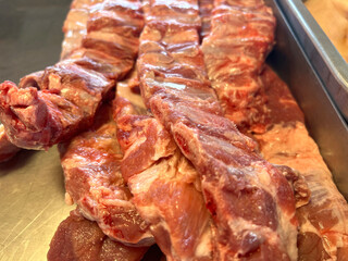 fresh pork ribs with meat and vegetables on the wooden table in a kitchen