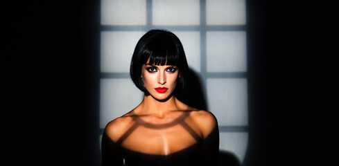 Beauty woman portrait in night shadows. Fashion portrait. Sensual brunette model face in night light. Beauty female face. Sexy beauty woman in studio dark light. Beauty portrait.