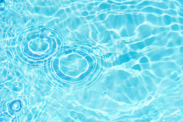 Blue water with ripples on the surface. Defocus blurred transparent blue colored clear calm water...