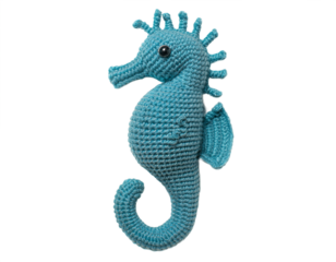 A charming crochet seahorse showcases its detailed texture and vibrant blue hue against a stark transparent background.