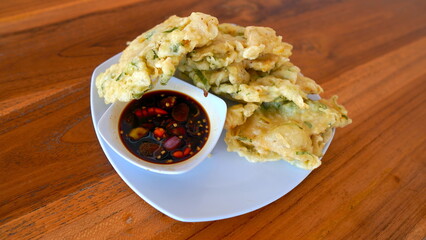 A high-angle, close-up view of a plate of crispy Indonesian Tempe, a fried Indonesian dish.