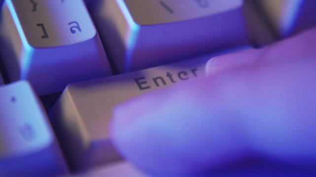 Pushing the Enter button on a vintage-style computer keyboard