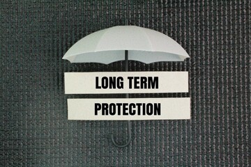 Umbrella and paper with the word long term protection. the sustained effectiveness of a vaccine or...