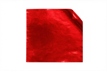 Crumpled red metallic foil with curled edge, reflecting light against transparent backdrop, showing glossy textural surface