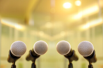 A lot of microphones on stand for press conference speaker reports interview or broadcasting public speaking speech presentation stage performance and reporter news.