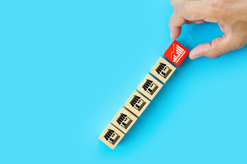 Hand choose wooden block stack with graph and franchise icon for goal to growth is investment planning financial and branch expansion and management bank loans or marketing franchising business.