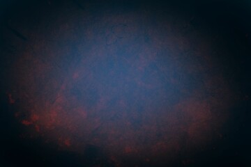 Abstract grunge backdrop blending deep blue and muted red hues while radiating subtle gradients