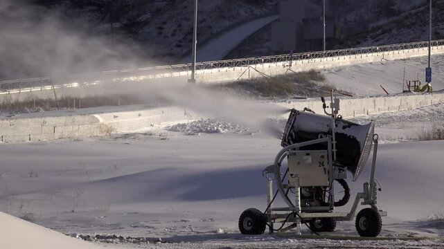 Artificial snow producing machine at ski slopes 4k