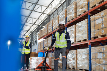 Warehouse worker pushing load cart, moving boxes of products, transfer or delivery control in warehouse