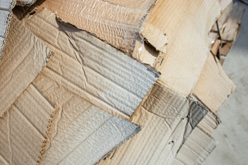 Obraz premium Waste weathered cardboard stack overlapping outside , garbage recycle concept, close up