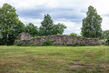 Stone walls ruins with trees in the background and lawn copy space