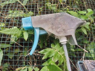 Close-up shot of a used plastic spray bottle cap, possibly from a cleaning product or cosmetic item,