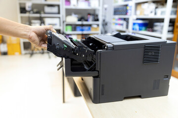Technician Holding ink printer toner low for replace new or fix repair problem paper or print...