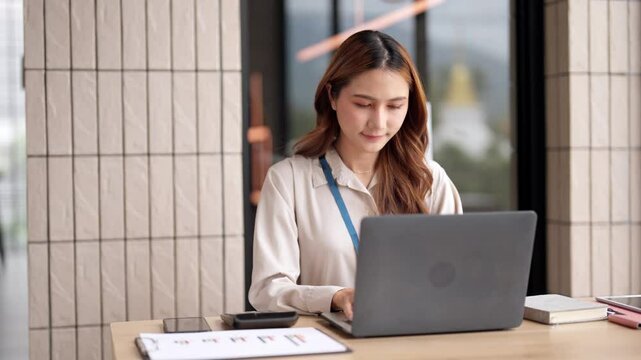 Confident Asian Young Adult Businesswoman Working Laptop Analyzing Finance Data Business Strategy Corporate Office Environment - Powered by Adobe