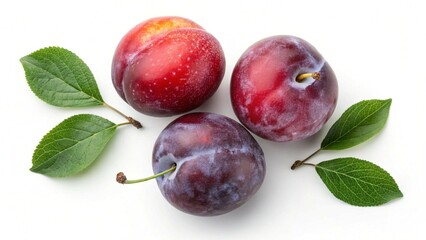Three fresh plums with leaves on a clean white background top view