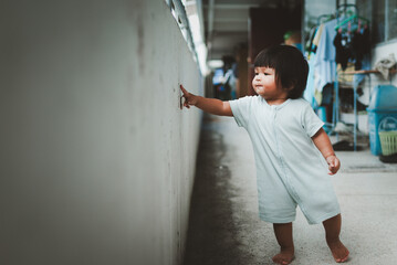 Children's exploration of life baby girl asian family urban environment candid moments
