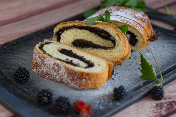 Poppy seed roll pieces decorated with greens and berries