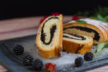 Poppy seed roll with a crispy crust and powdered sugar