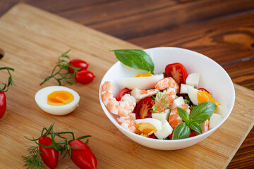 Summer salad with seafood and fresh vegetables in a bowl