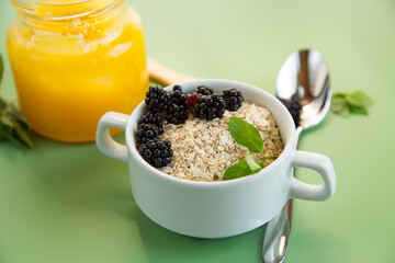 Bowl with dry cereal and berries on the background