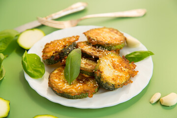 Fried zucchini with garlic and basil served hot