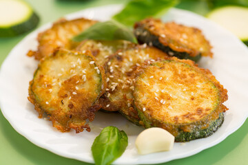 Delicious vegetable side dish of fried zucchini on a light background