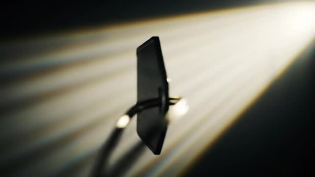 Close up of a black ten percent off tag with a gold string on a dark background with light rays