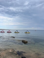 catamarans at sea on a cloudy day