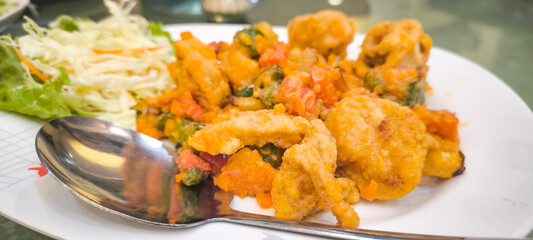 Squid stir-fried with salted eggs in a restaurant