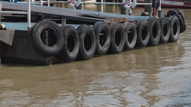 The hanging tires act as shock absorbers and fenders for the boat.
