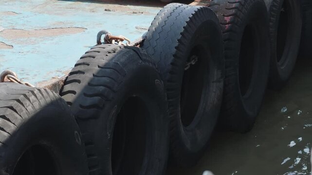 The hanging tires act as shock absorbers and fenders for the boat.