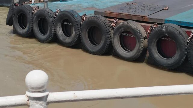 The hanging tires act as shock absorbers and fenders for the boat.