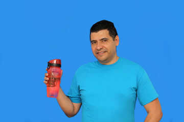40-year-old dark-skinned Latino man shows his plastic bottle to carry water and avoid waste