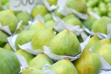 Fresh green figs displayed at a local market