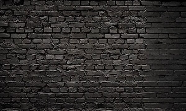 A dark brick wall with visible mortar and a rough texture creating a solid and uniform background